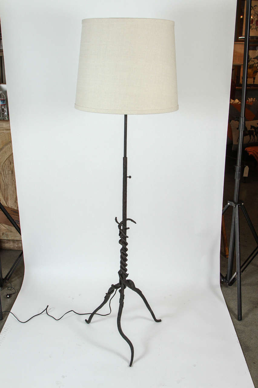 Vintage hand-forged wrought iron lamp, newly rewired with new custom linen shades. Height is adjustable. Sockets for two bulbs with pull chains.