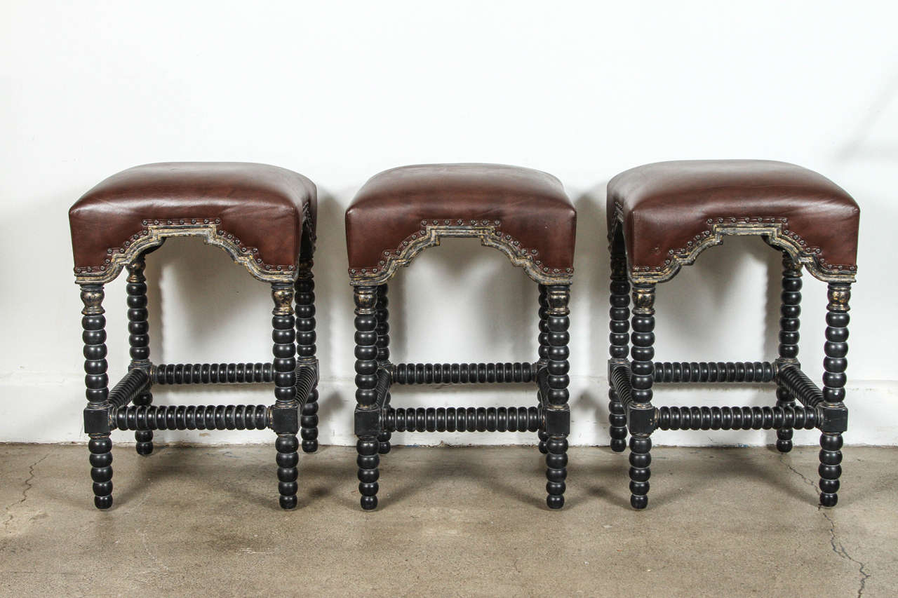 Great looking Classic Spanish style bar stools, with beautiful brown leather upholstered, nice brass nailhead trim and turned wood in ebony color.
Perfect for any place in need of a bar stool, stylish and comfortable.