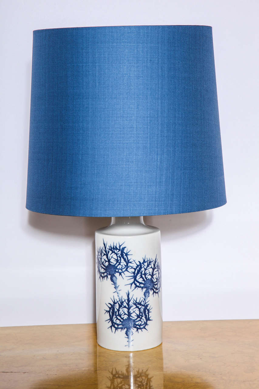 Pair of ceramic table lamps by Kaj Lange by Royal Copenhagen for Fog & Morup.  Bases have a Thistle pattern in blue with original linen shades.