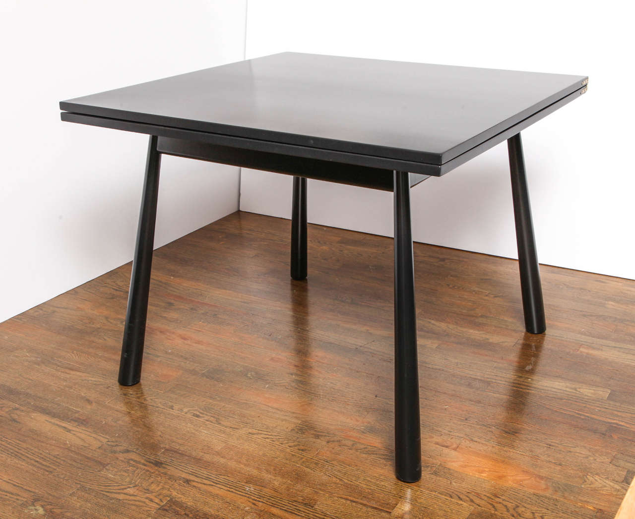 Black lacquered flip-top dining table by T.H. Robsjohn Gibbings.  Folds into a 38