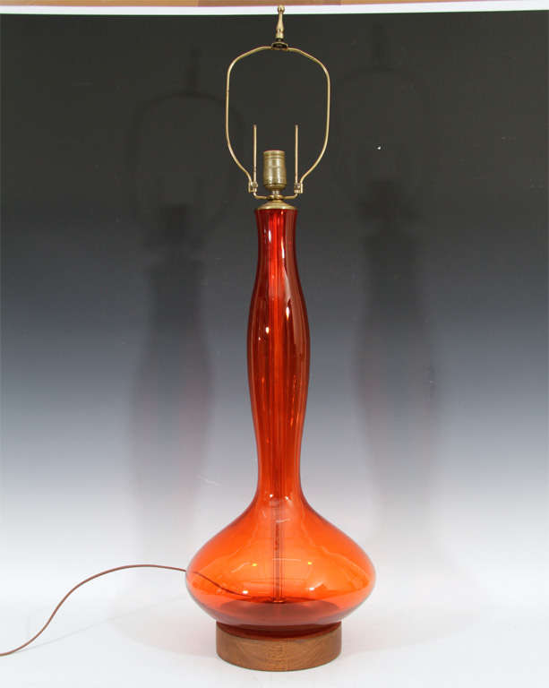 A pair of tall table lamps with translucent orange glass bodies by Blenko.

Reduced From: $1950