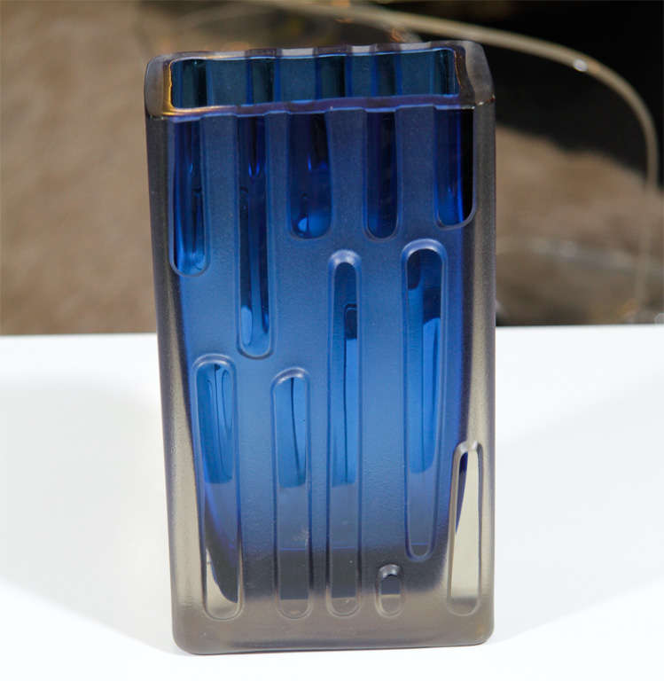 Art glass vase with a cobalt blue interior surrounded by a frosted glass exterior with polished clear geometric stripes.