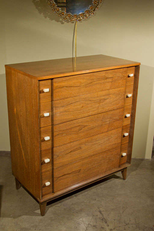 A mid-century five-drawer high-boy dresser of nice design and condition.