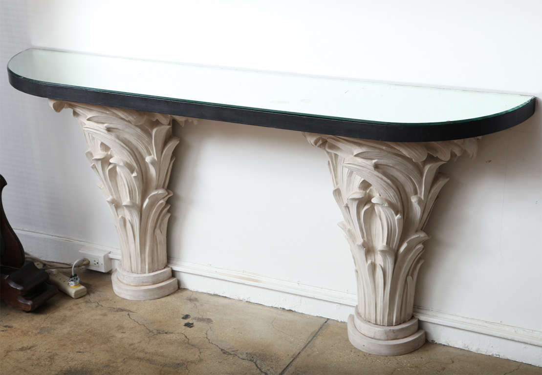 A console in Serge Roche style, with twin floral pedestal bases in plaster supporting a mirrored top