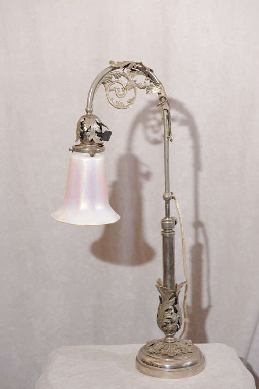 This most unusual lamp has a very unique silvered patina and beautiful castings all around. Measure: The height can be adjusted from 22