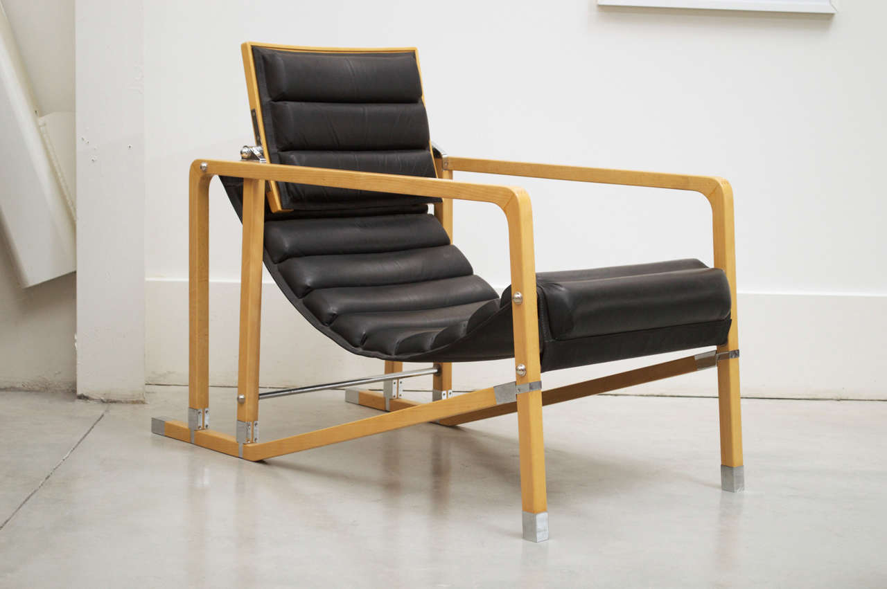 A mid 1970s re-edition of an Eileen Gray chair designed in 1927. Made of wood and black leather. Head rest adjustable.