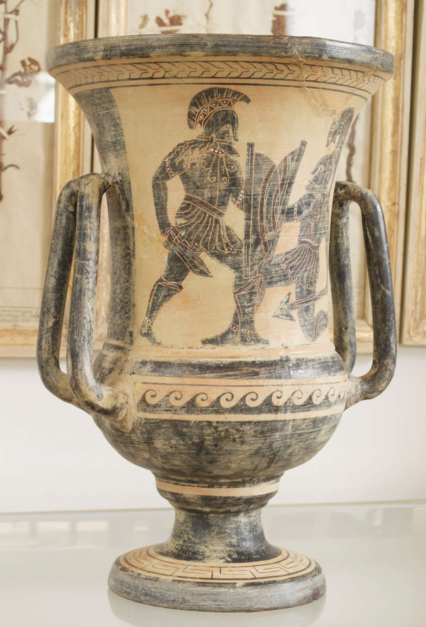 Turn of the century double arm large grand tour pottery vase in ancient Etruscan style. The facade with two warriors . The reverse with a large anthemion acanthus leaf. The base signed with the monogram 