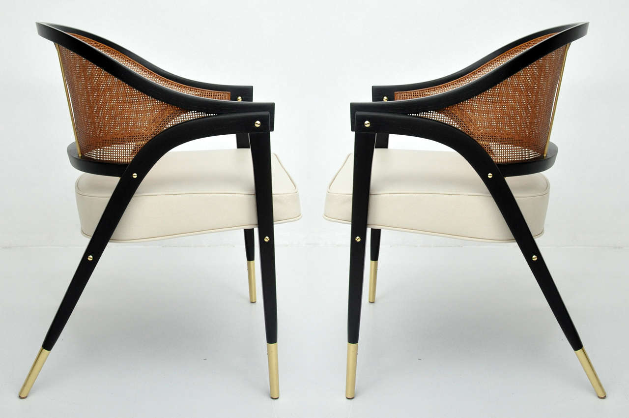 Pair of arm chairs designed by Edward Wormley for Dunbar.  Fully restored.  Refinished espresso tone frames, new cane backs, and fresh leather seats.

