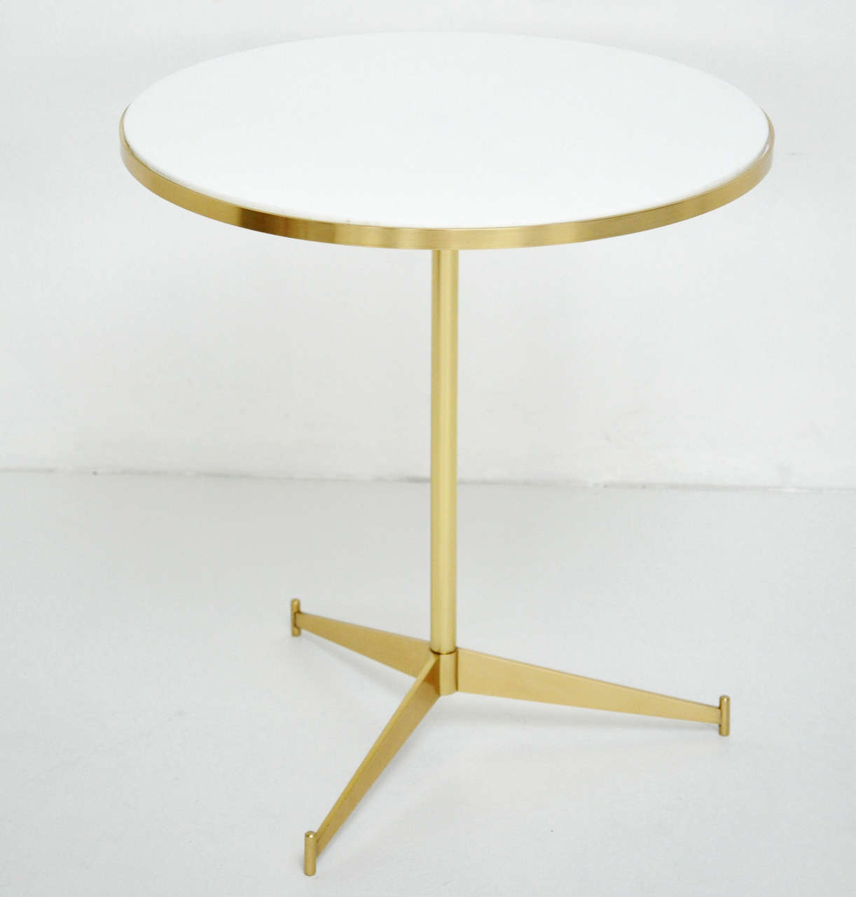 Paul McCobb brass tripod table for directional.  Original white vitrolite glass.  