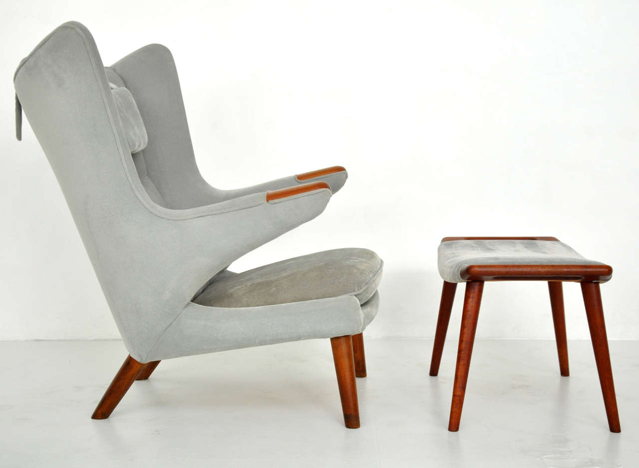 1950s papa bear chair and ottoman by Hans Wegner. Teak paws and legs. Reupholstered in grey mohair about 5 years ago.