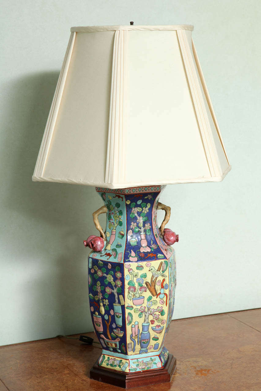 Decorated throughout with vases holding cherry blossoms; mounted with twig-form handles terminating in large cherries.  Height of vase alone is 17 1/4