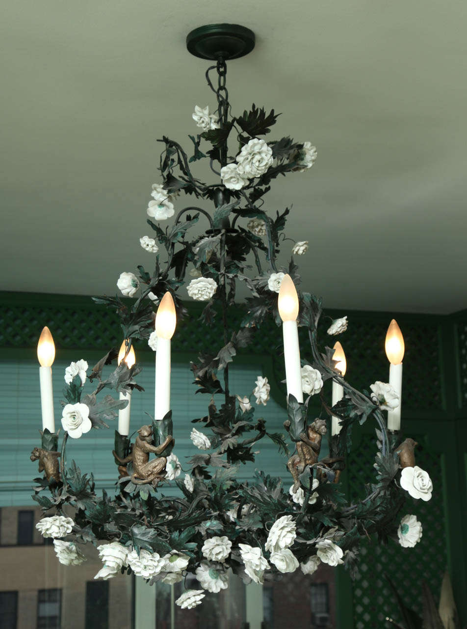 The whole entwined with trailing porcelain roses; each electrified candelarm embraced by a monkey.  See listing for matching sconces.