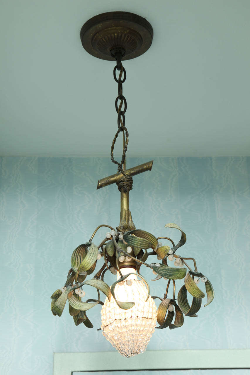 With gilt-metal bamboo issuing green tole foliage and the crystal beaded bulb cover.