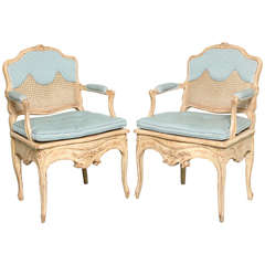 A Pair of Louis XV Style Caned and Painted Armchairs