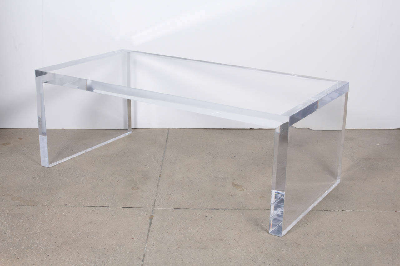 This solid, heavy and gleaming lucite coffee table is absolutely stunning and perfect for any decor. Made of thick, 2