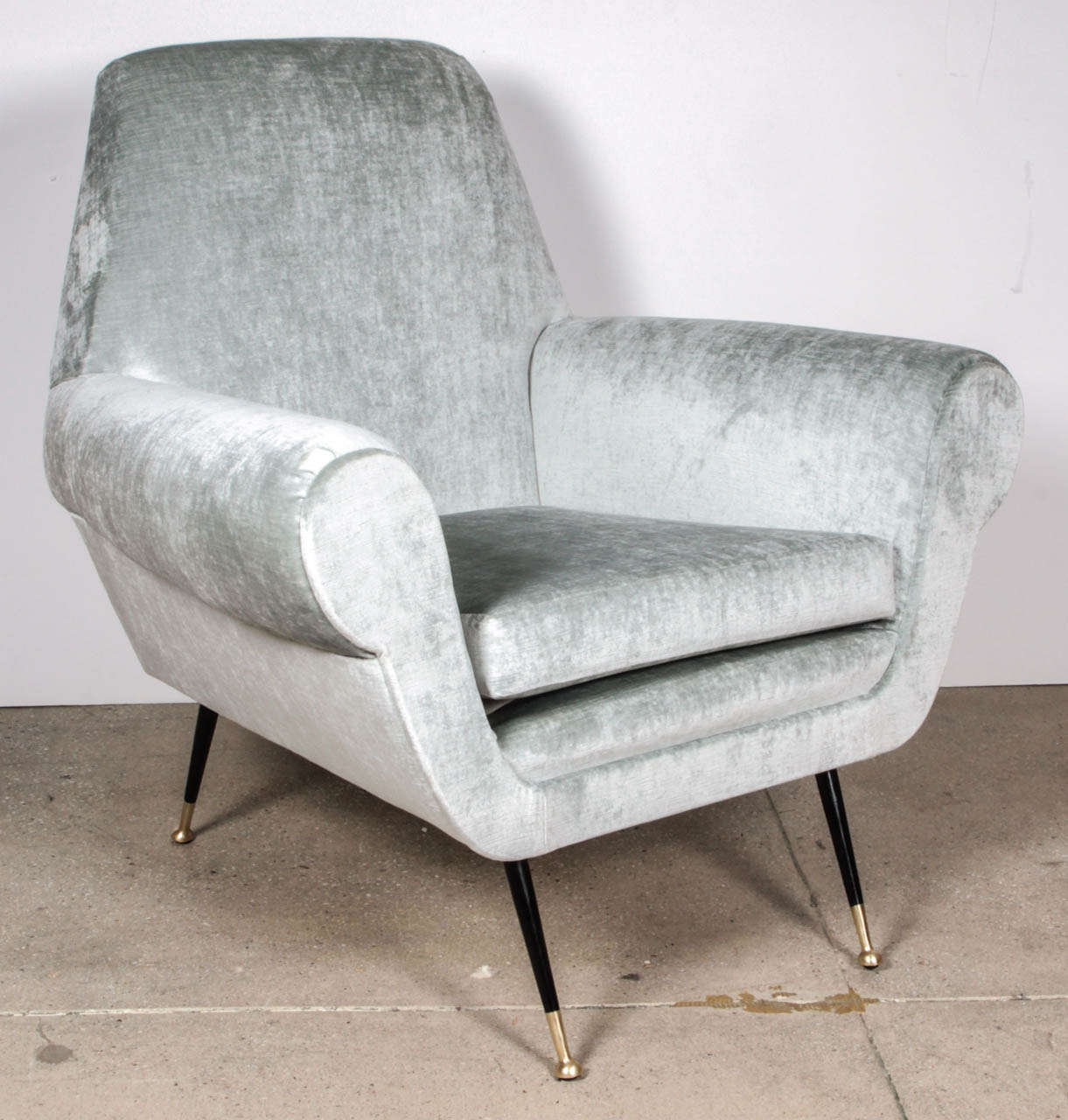 Recovered in light blue grey velours.  The legs are in metal.  Black lacquered and gilt.