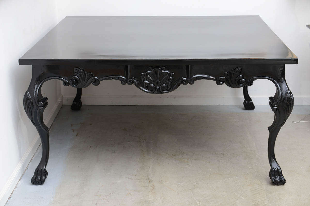 Black lacquered table with paw feet