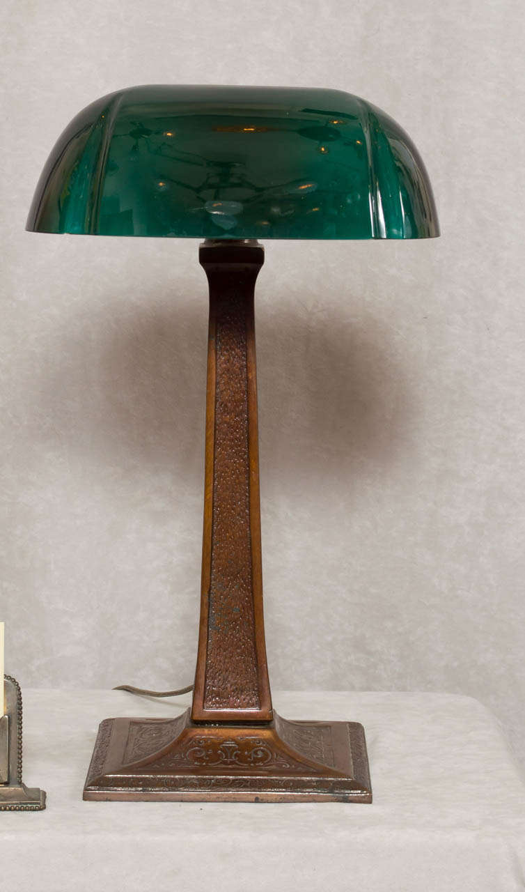 While Emeralite was the most prolific maker of these style lamps, Aladdin made the premiere models.  This lamp is all cast bronze.  There is no iron weight on the bottom or thin pieces of brass; it's all cast bronze and has beautiful detailing on