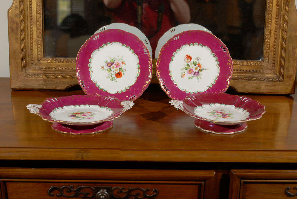 A set of four English Copeland red border dessert plates and compotes from the mid 19th century, priced and sold individually. Born in England during the 19th century, each of these four Copeland pieces features a red border, surrounding colorful