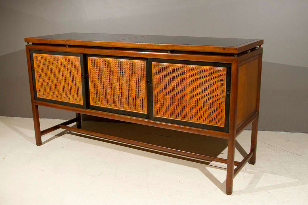 Walnut sideboard, with sliding caned doors from Baker's New World Collection by Michael Taylor.