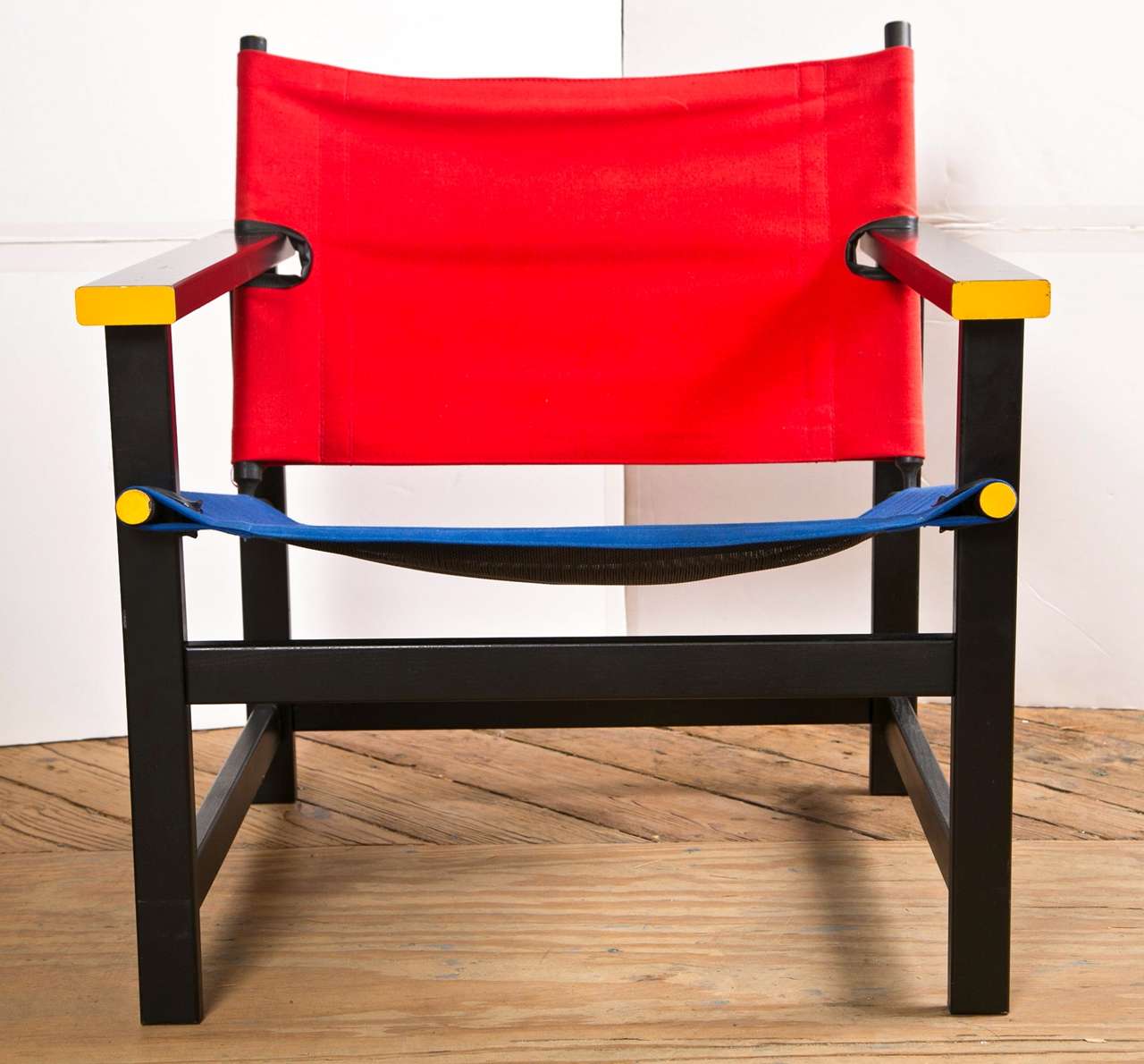 Gerrit Rietveld was a renowned Dutch furniture designer and architect. He was one of the principal members of the Dutch artistic
movement called De Stijl. He is famous for the wooden red and blue
chair.
This is a canvas seat and back chair used