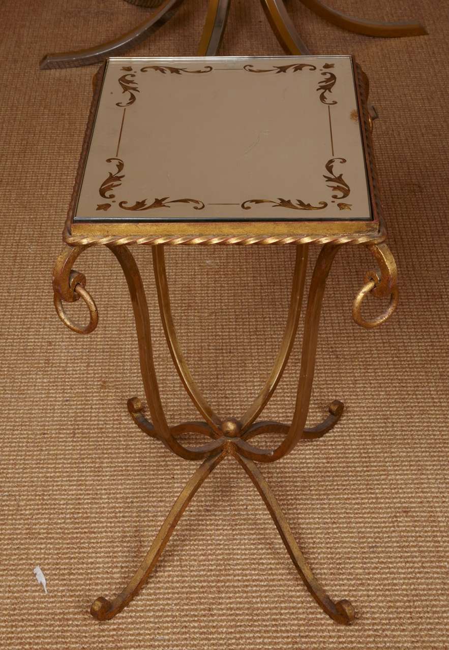 Pair of gilt wrought iron side tables, top eglomized mirror, different drawings on each top
