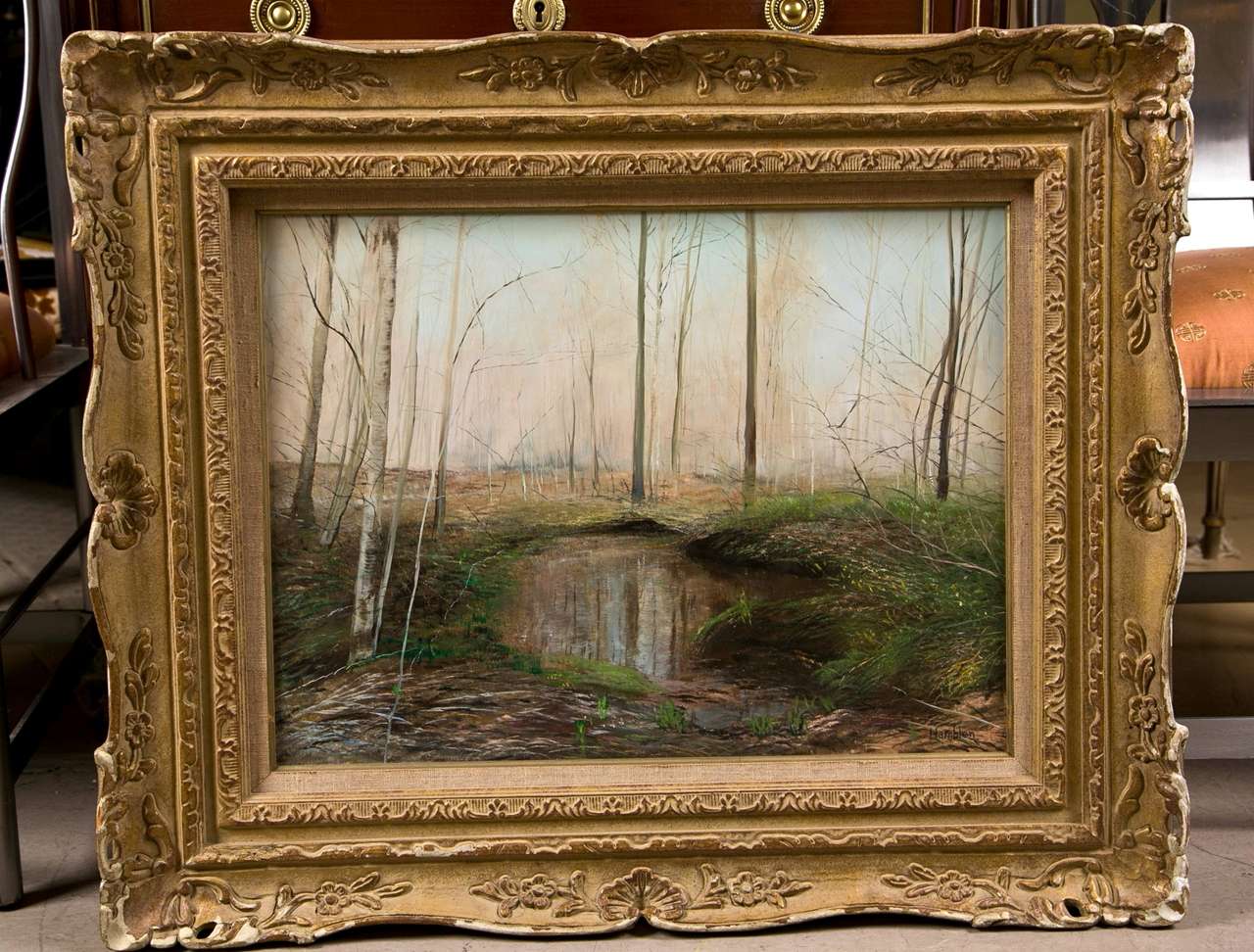 An early oil on canvas signed by Hamblen. Titled Early Spring Reflections. Artist information on reverse. Wonderfully framed in a solid gilt gold wood frame sits this spring time oil.