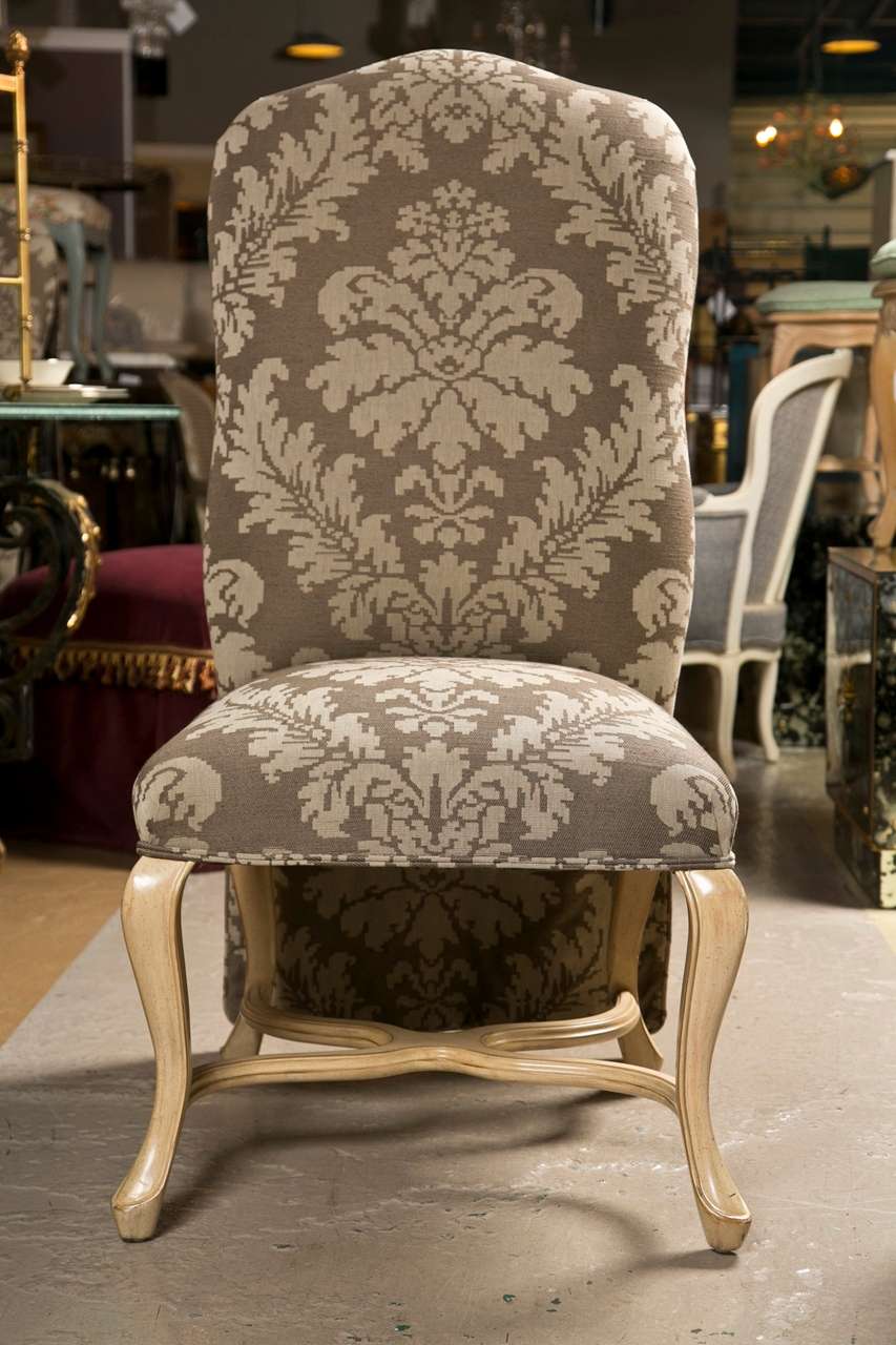 A very good set of six dining room chairs by Kreis. Each having a Queen Anne style painted set of legs with a double C framed undercarriage. The seat and backs all-over upholstered with draped rears. This set comes with a full set of six custom