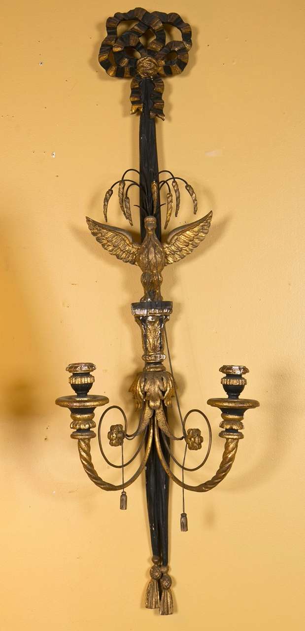 A fine pair of two-light wall sconce. Each ribbon form in the Federal taste having gilt tassels and bow design with ebonized hi lights. Both depicting a winged eagle in flight.  Hardwired. Cracks and splits as is intended. Some old professional
