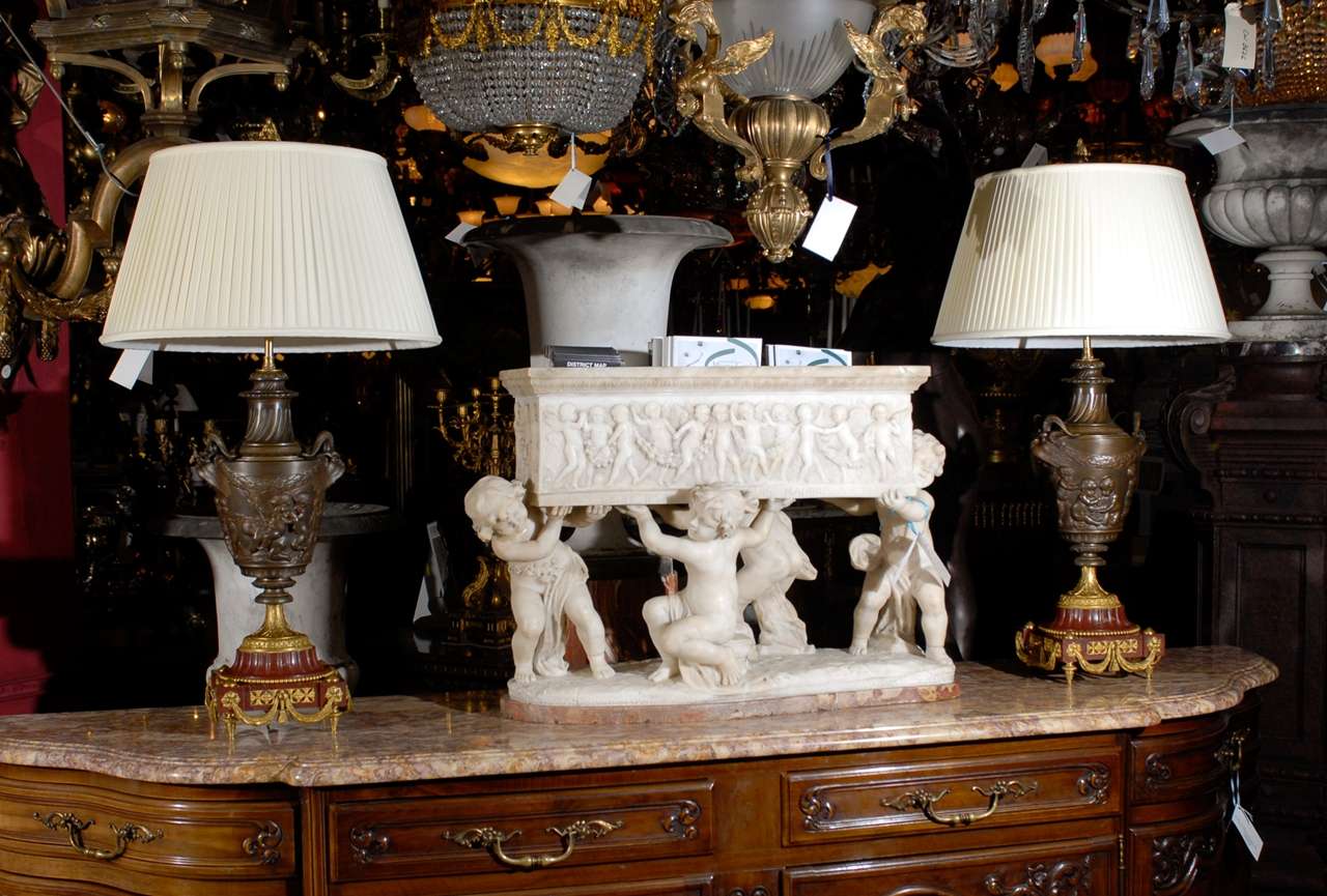Magnificent pair of patinated and gilt bronze lamps with rouge marble bases