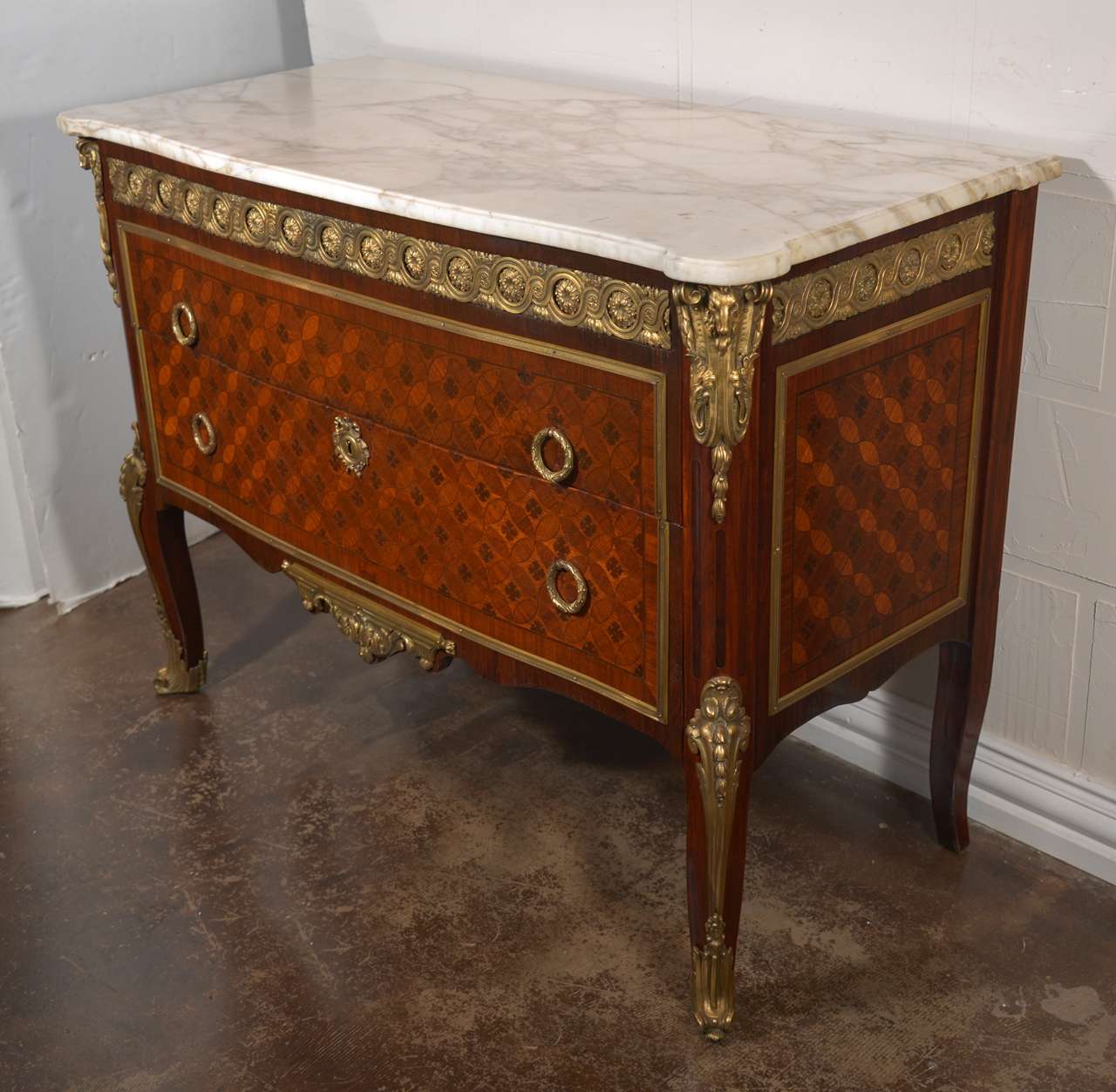 Beautiful first quality 19th c Louis XVI mahogany and kingwood marble topped commode. The commode has beautiful gilt bronze mounts with rams head details