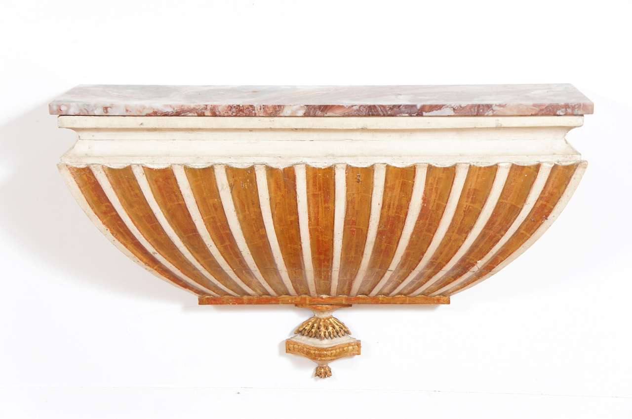 Nice Italian white-painted and parcel-gilt wall mounted console table. Marble top on a painted and gilt base.