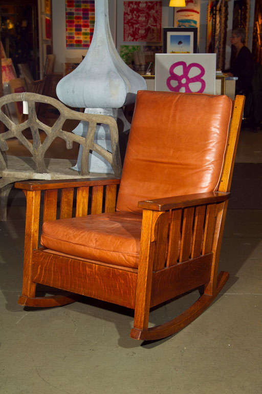 Gustav Stickley rocker, #323, five horizontal slats at back and five vertical slats under each arm with corbel supports at sides, recovered cushions, back cushion included, refinished, signed with red decal, 29