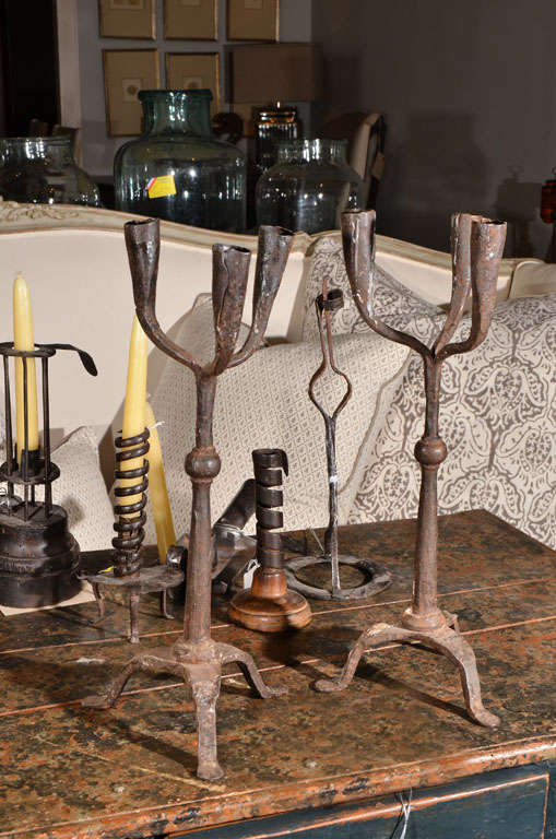 Pair of primitive forged iron candlestands, each for 3 candles.