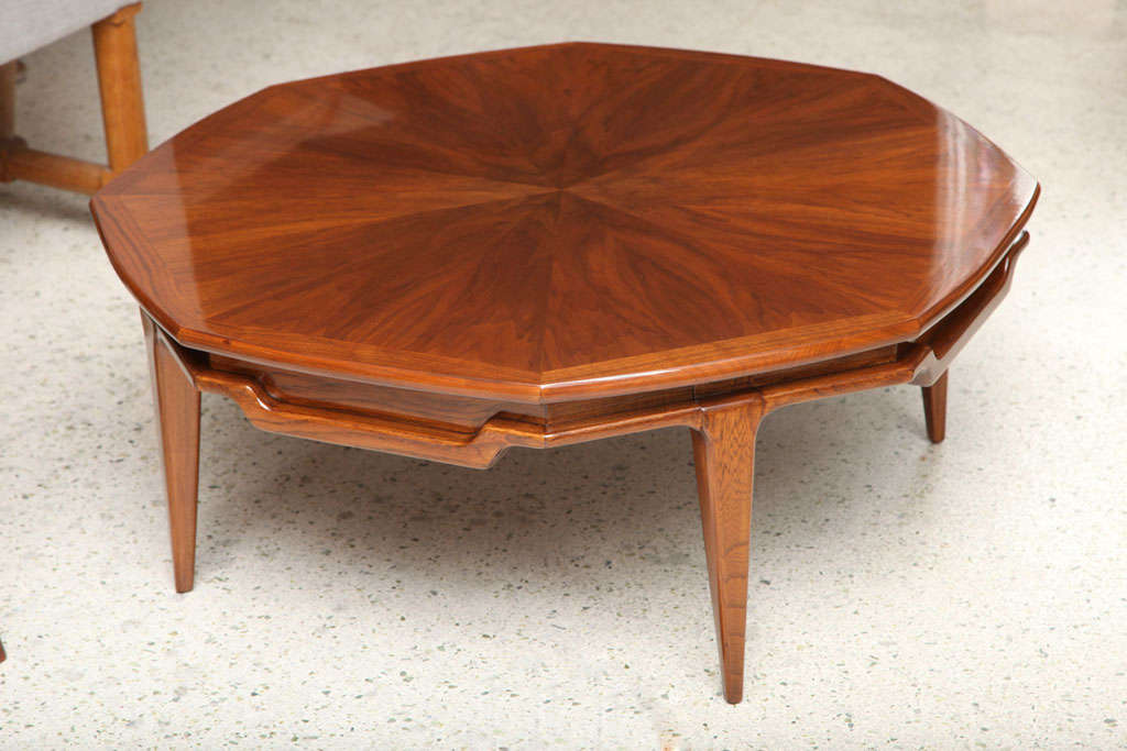 The octagonal top with radiating veneer and band inlay above an undulating frieze on tapering legs.