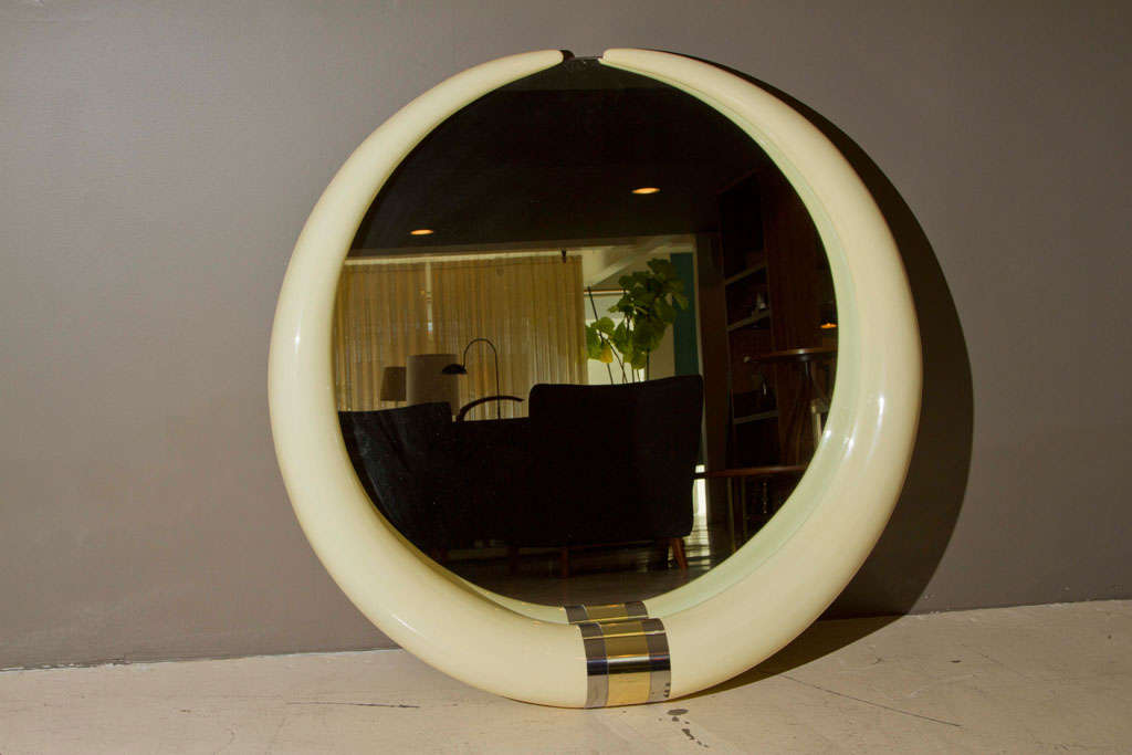 Glamorous Hollywood Regency style round wall mirror with faux-tusk frame.  Attributed to Karl Springer.