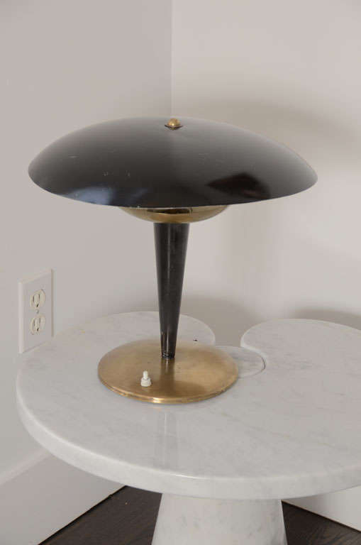 Italian Table Lamp In the Style of Stilnovo
Adjustable Enameled Round Shade  Fitting to a Enameled Metal Stem Standing on a round Brass Base