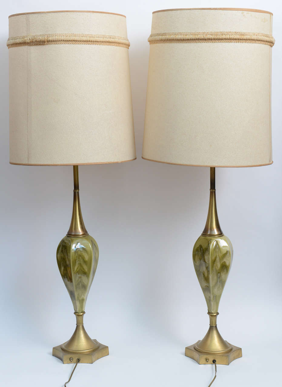 Those glamorous, chic and elegant lamps can add delicate opulence to your room. Green, gold and white swirls bedeck the ceramic hearts of the lamp, coupled with matte antique brass bases. Original embroidered shades adorn the lamps for additional