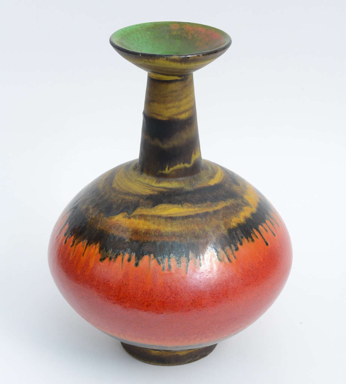 This unique Italian modernist pottery by by Alvino Bagni for Raymor, showcases the best of the techniques. Beautiful hues of orange, yellow and dripping black with a hint of green complement one another perfectly. Base of the vase is hand-signed