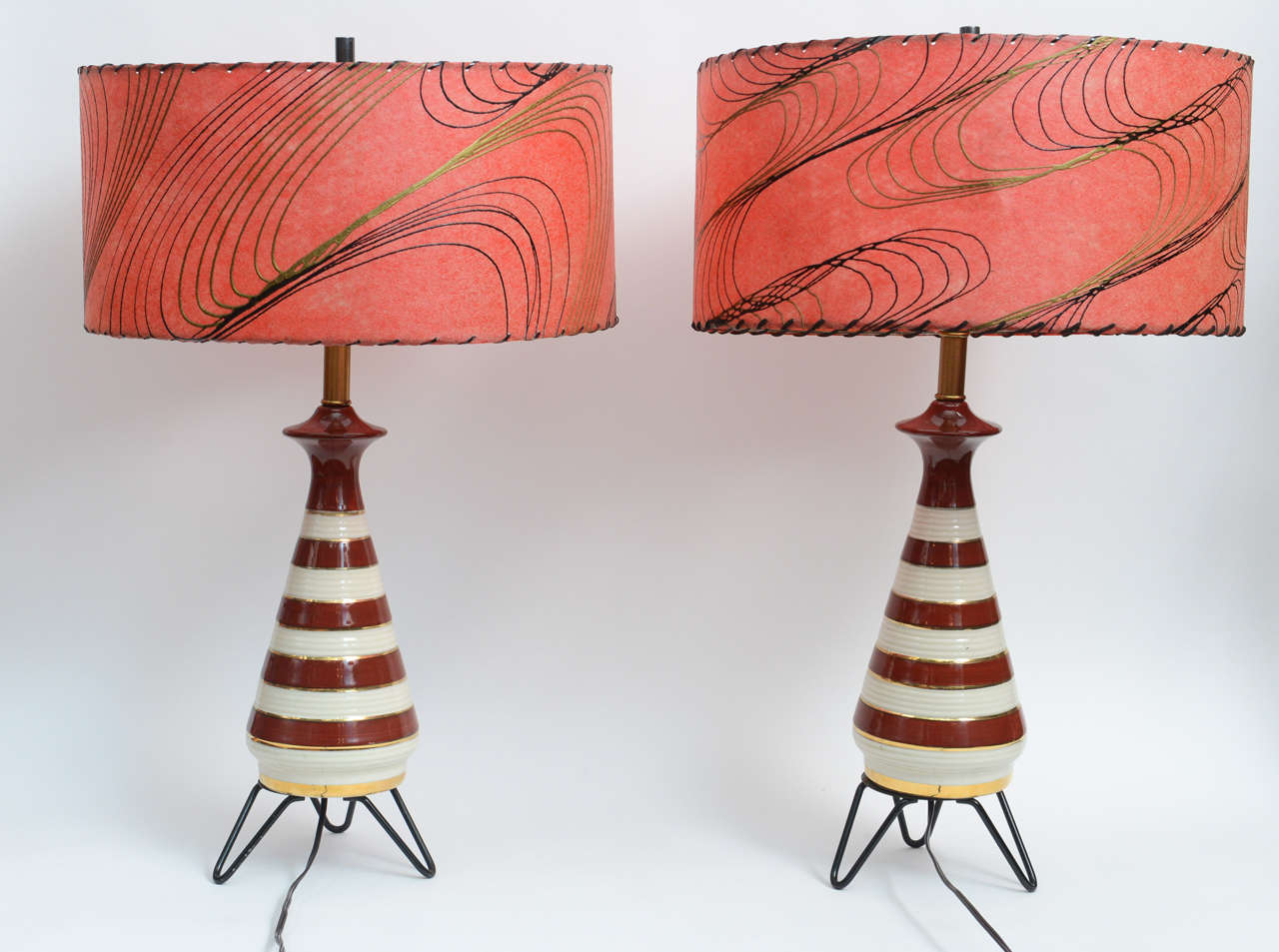 Incredible, inimitable, classic:  these table lamps take you back to Italy with Sophia Loren or Vegas with the Rat Pack. These beautiful ceramic lamps come with their original shades.  The bases include glossy concentric stripes of white, gold and