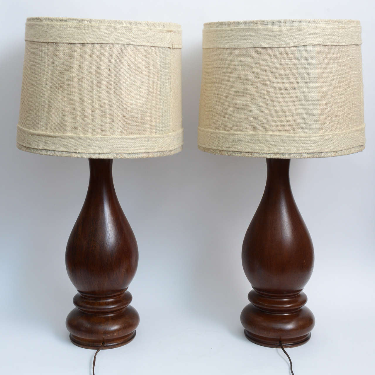 The simple shades and curved lines of these lamps will bring warmth to your room. Original linen open-weave shades give them an organic quality. Beautiful Classic vase-like lines on both lamp bases make them an easy Classic. Lamps are mid-sized.