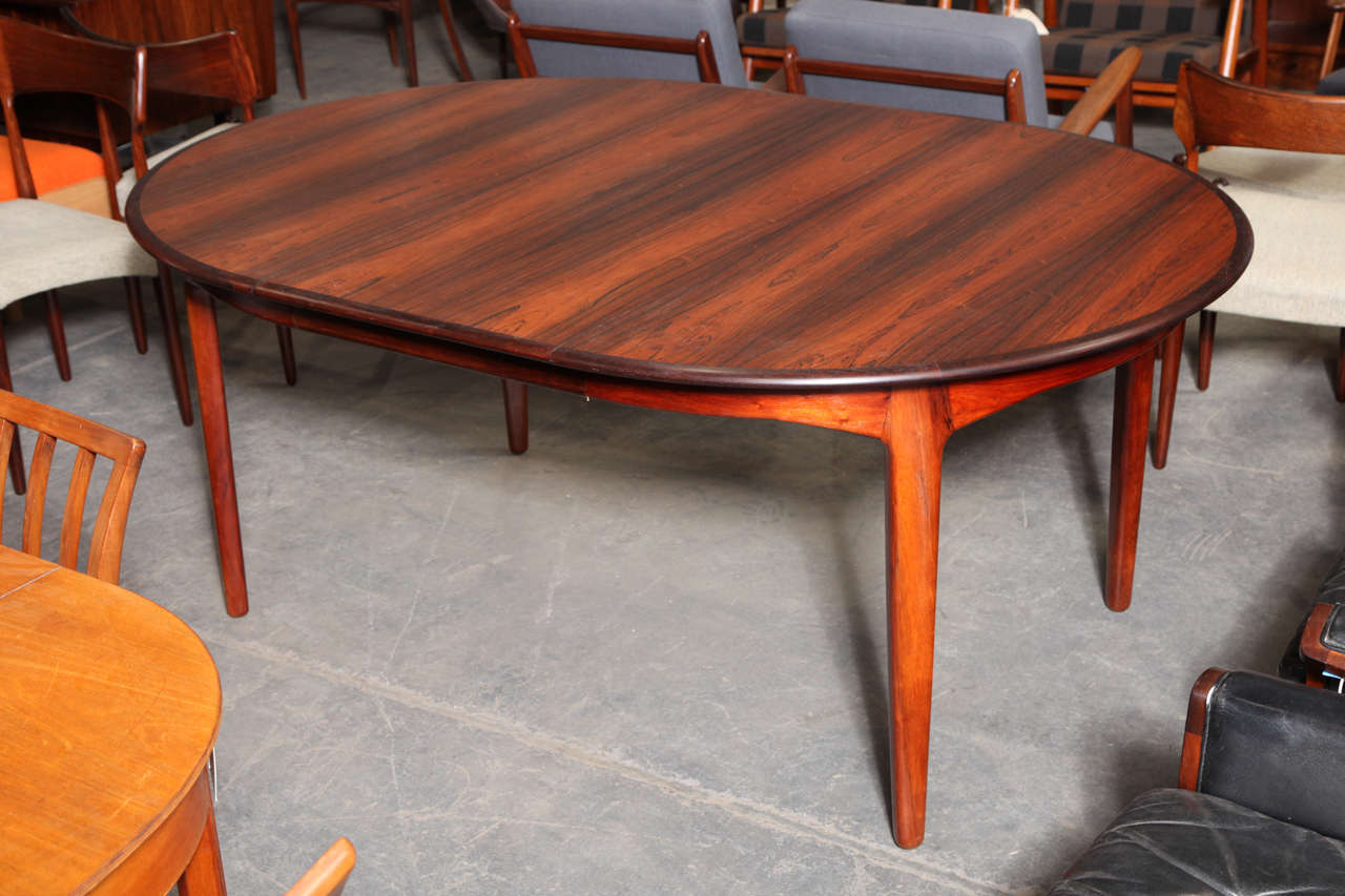 Vintage 1960s Formal Dining Table with 4 Leaves, Seats 12 People

This Rosewood Dining Table comes with four leaves. One leaf has the bottom apron so you can set it is an oval table if you like. The other 3 leaves do not have the apron so they can