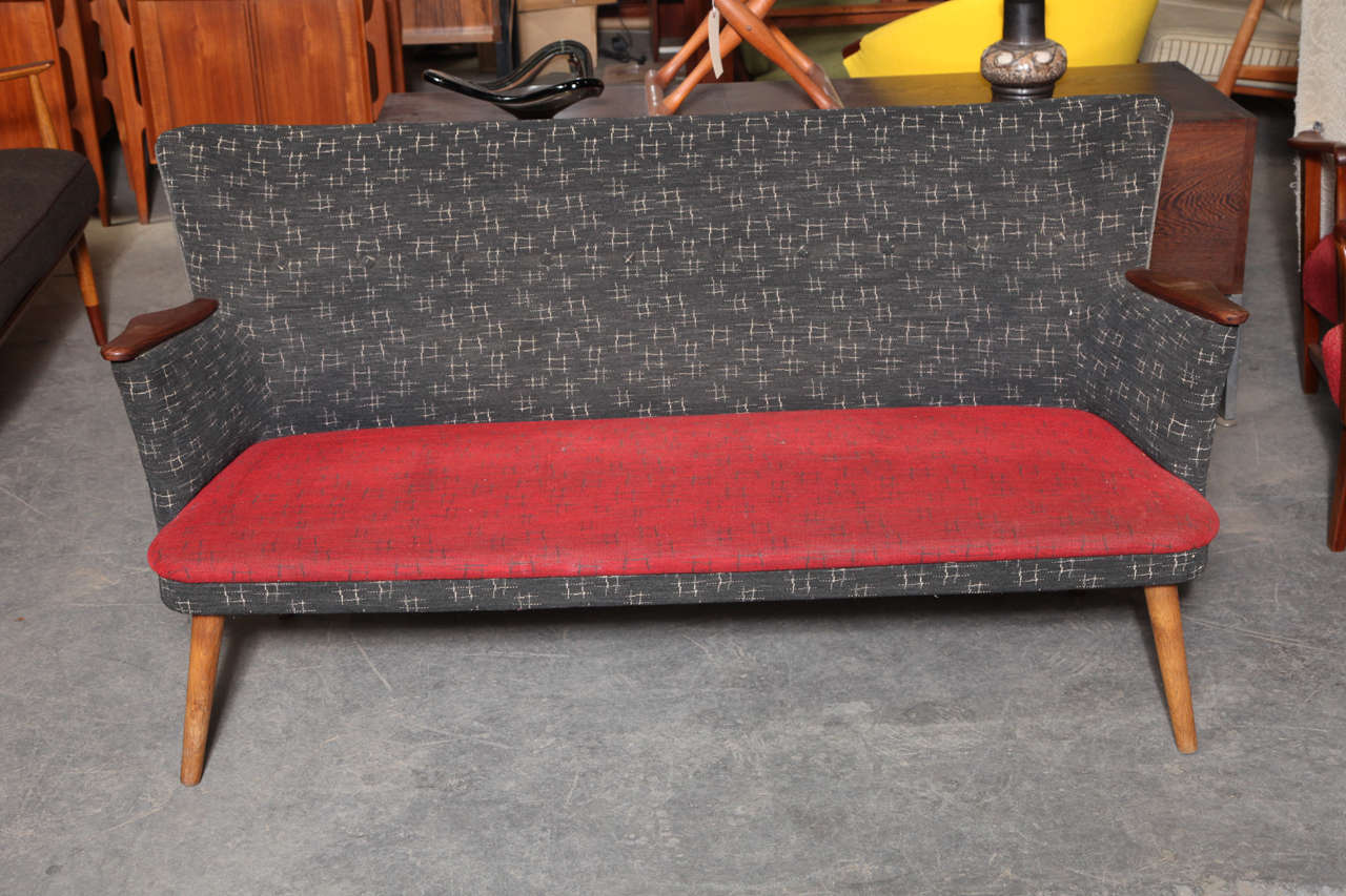 Vintage 1950s Retro Sofa with Splayed Legs from Norway

This Red Sofa is accented with a charcoal fabric on the back and arms. The fabric is vintage condition that shows well, or we can re-upholster it to fit your style. Small and compact, yet