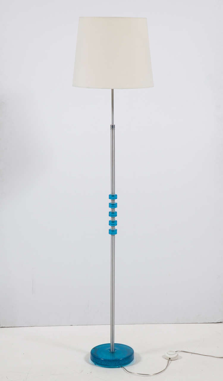 A vintage floor lamp in chrome with a stunning blue crystal base and blue crystal accents on the rod.