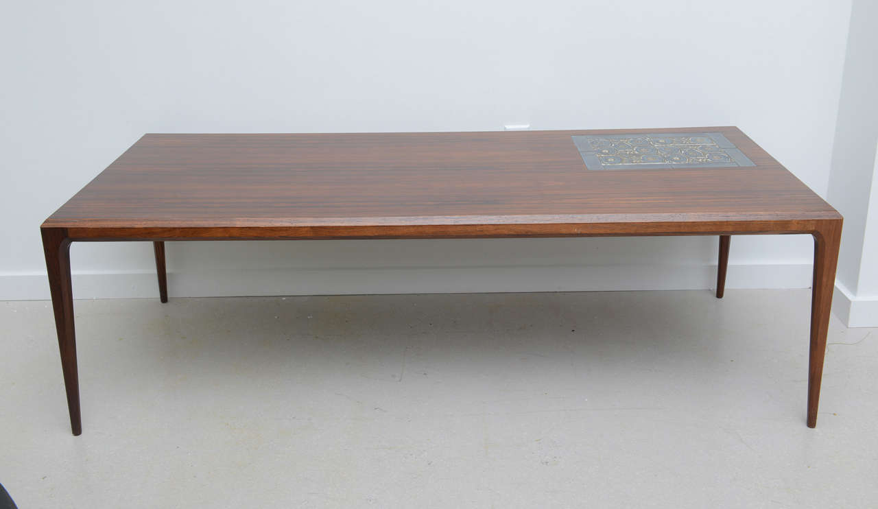 Danish modern beveled and joined rosewood coffee table. Faience tile inserts from 
the Aluminia division of Royal Copenhagen.