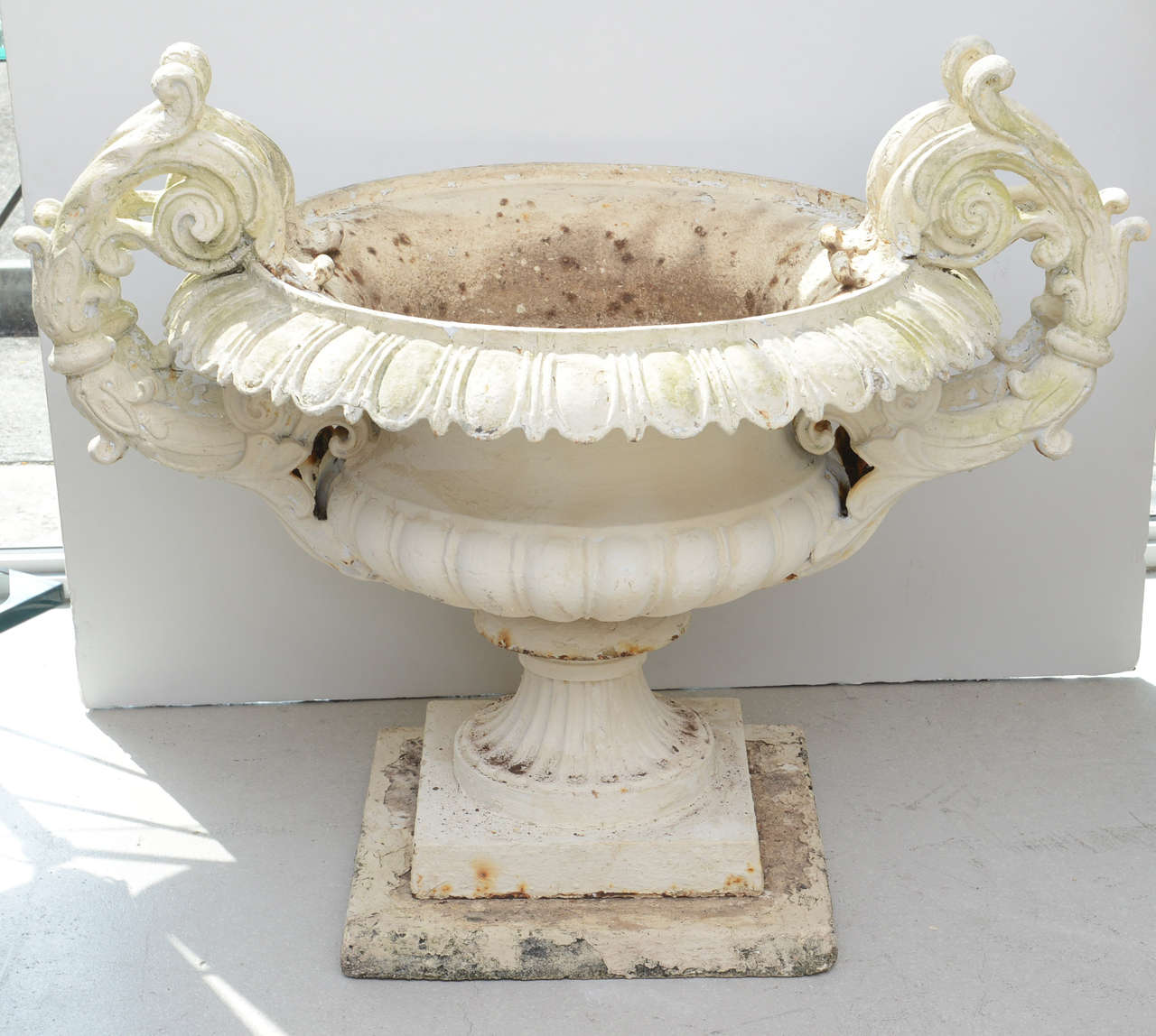 Large painted white J. W. Fiske cast iron urn in the neoclassical style.