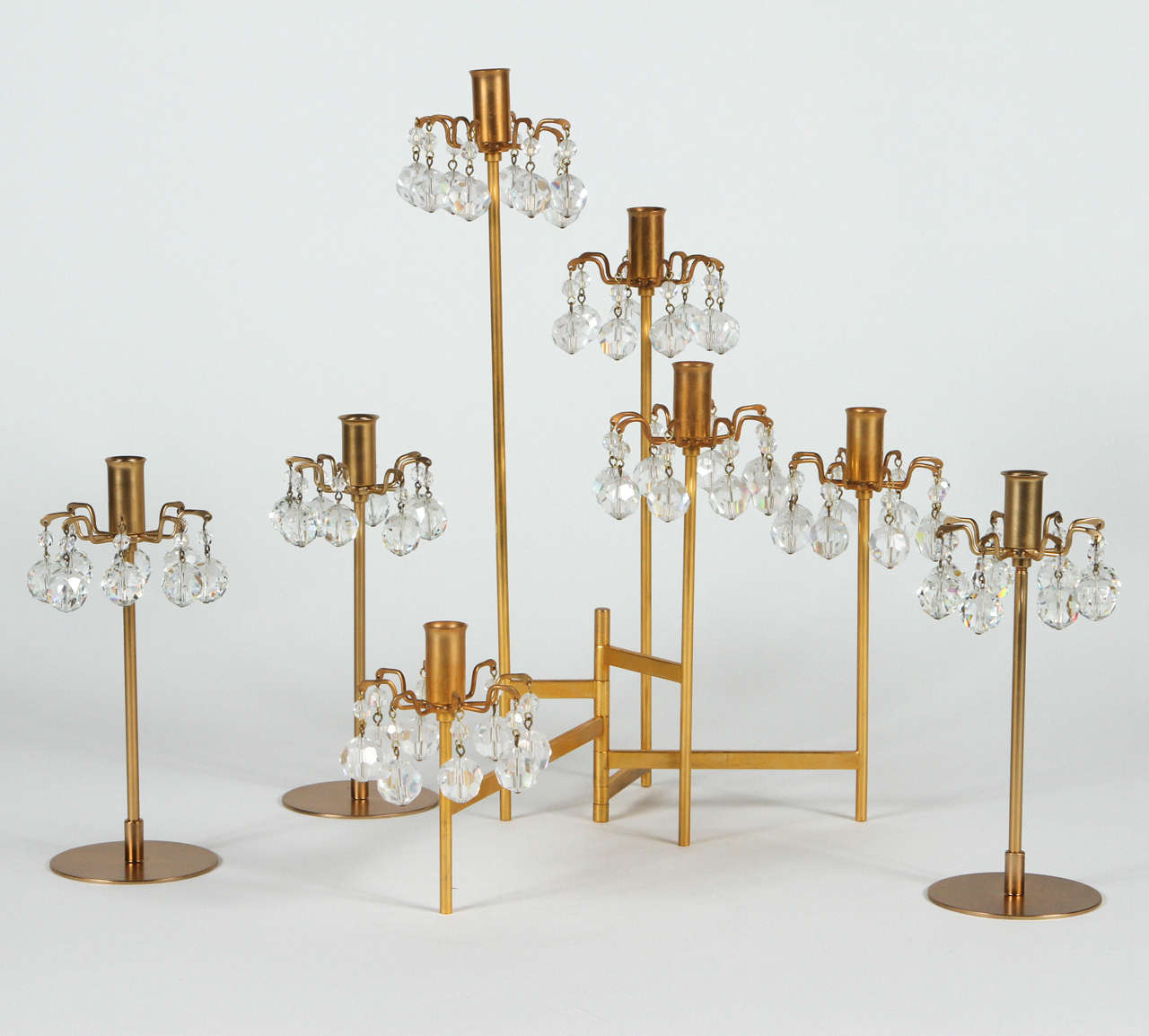 Grouping of gold-plated Lobmeyr candelabrum with crystals. The larger adjustable five-arm is of the Met series by Hans Harald Rath, the designer of the 1966 Metropolitan chandeliers for the new Metropolitan Opera House, New York. Signed.

Visit
