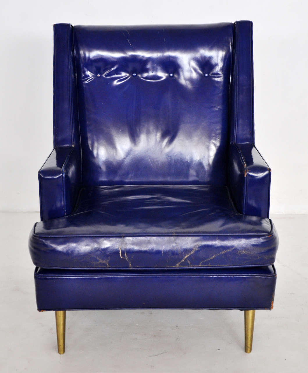 Lounge chair designed by Edward Wormley for Dunbar. Original blue leather over brass legs.