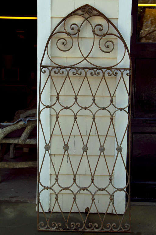 Beautiful rounded and swirling shapes made up this large hand wrought iron architectural feature.  Can be hung as an indoor decorative element or used outdoors as a garden feature.