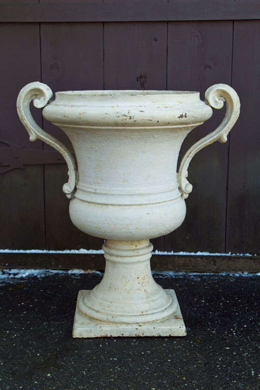 The strong linear design of these urns is typical of the formal style of French gardening popularized by Andre Le Notre